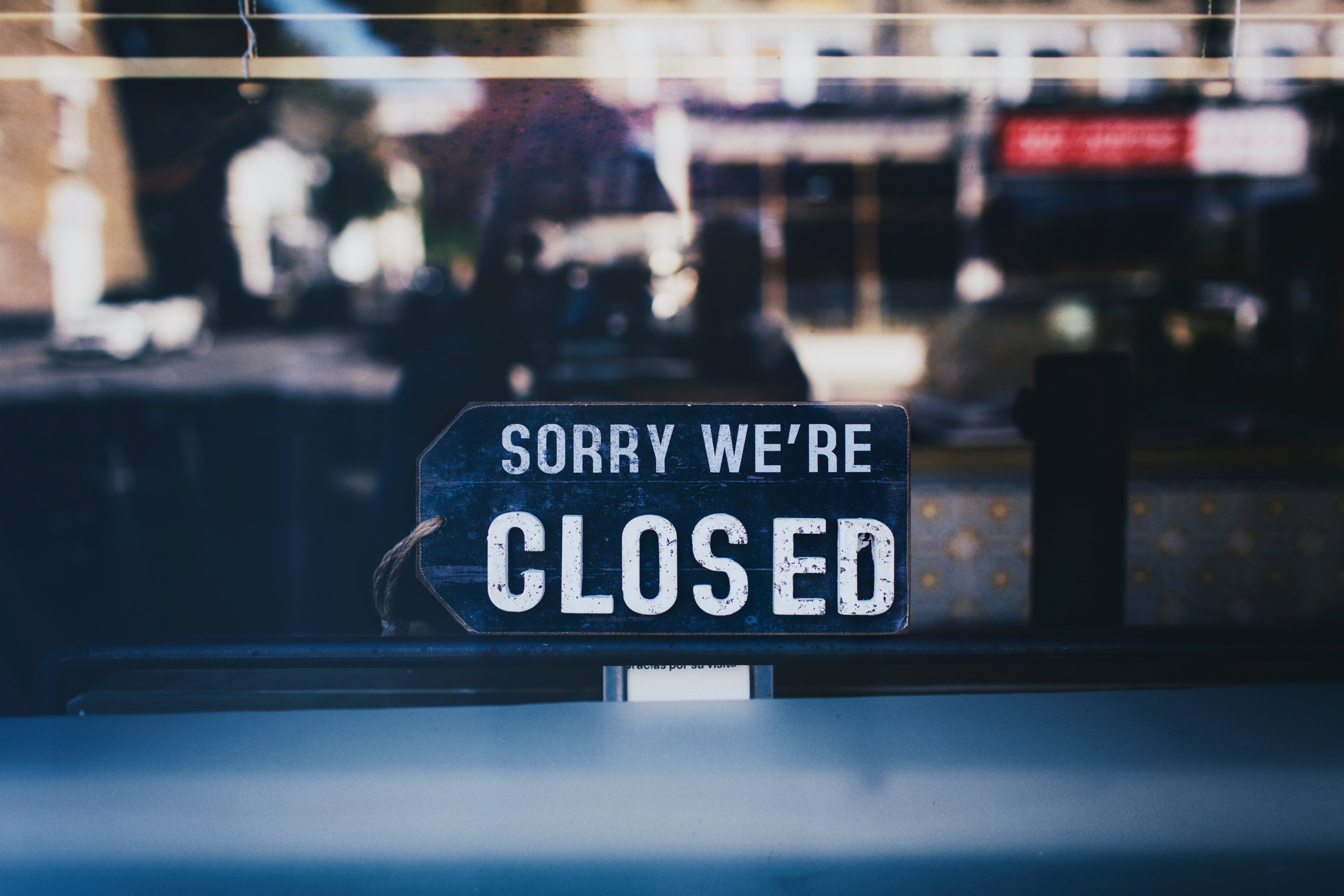 close-up-photo-of-sorry-we-re-closed-sign-on-glass-window-2467649