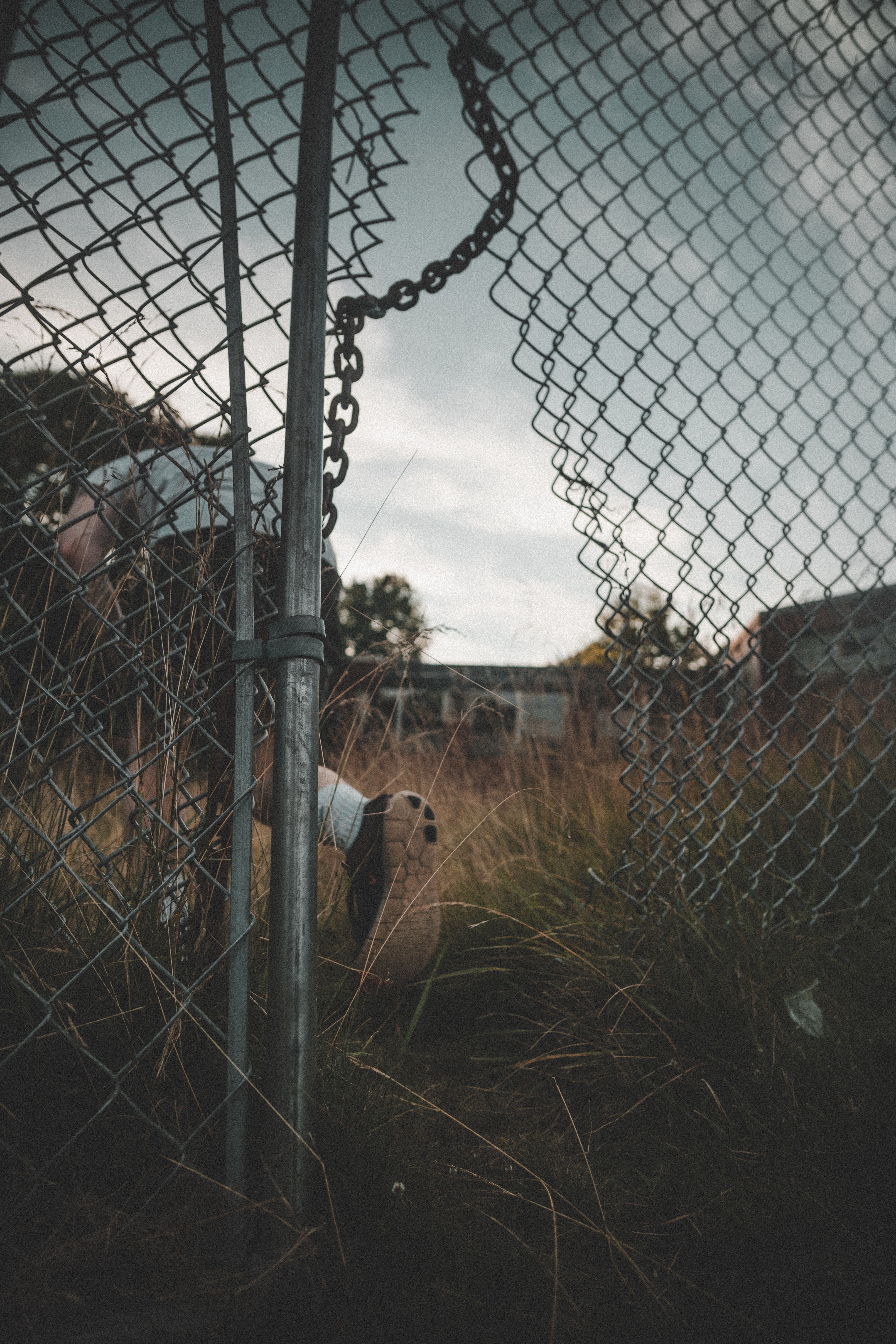 person-going-through-a-broken-wire-fence-2953898